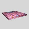 Pink mattress with cartoon patterns on a gray background