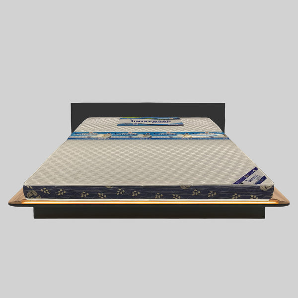 Mattress on a wooden bed frame with a gray background
