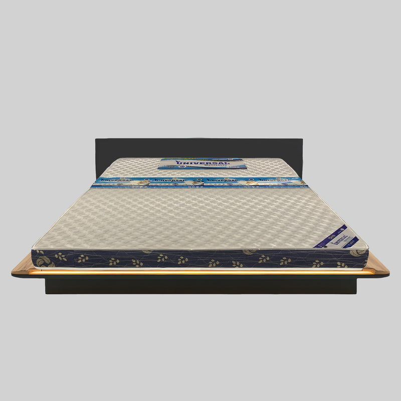 Mattress on a wooden bed frame with a gray background