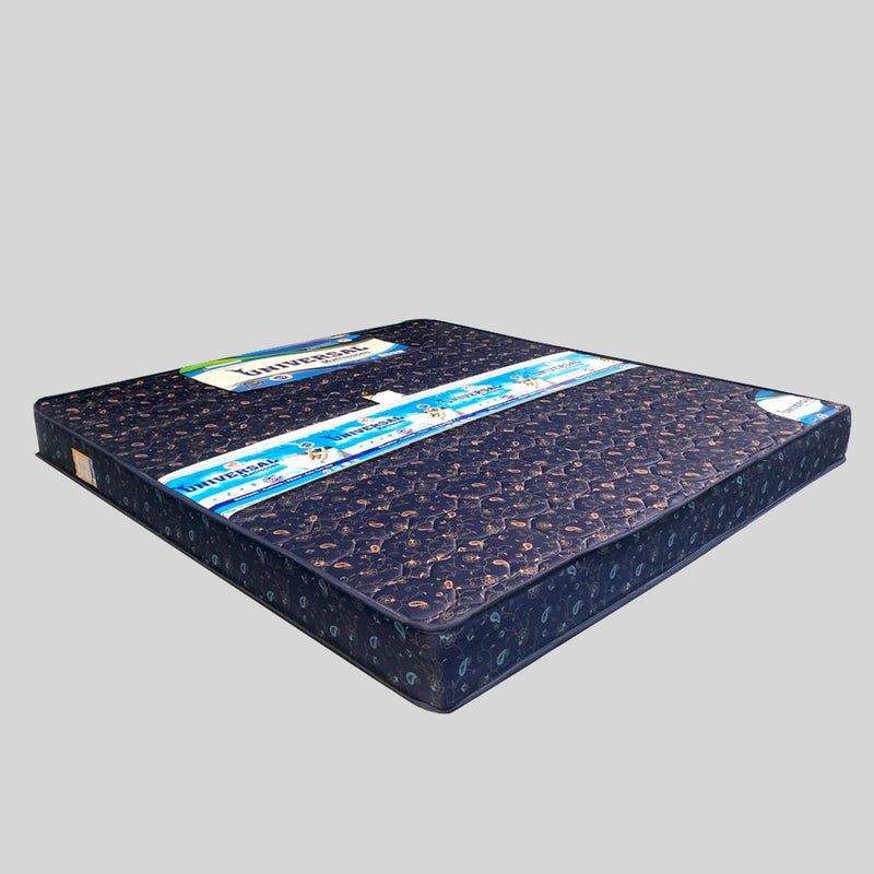 Blue mattress with brand label on a gray background