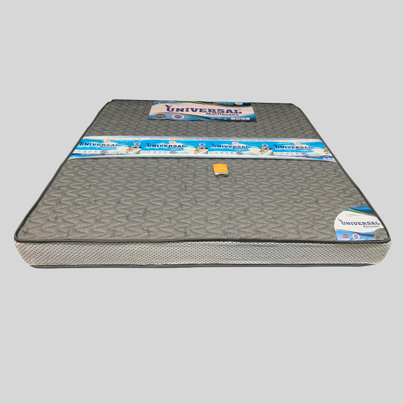 Gray mattress with 'Universal' branding on a gray background

