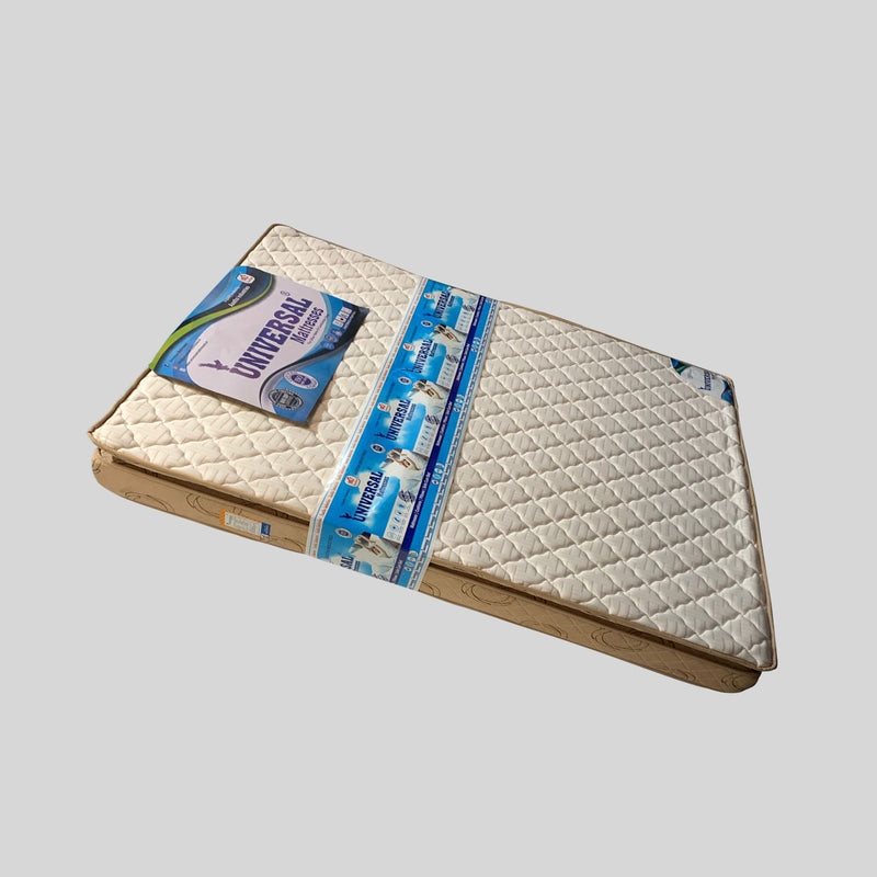 Folded mattress with packaging on a light gray background