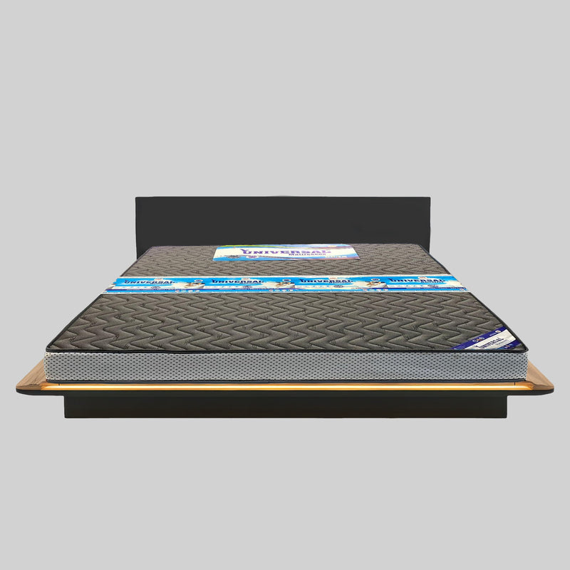 Mattress on a wooden bed frame with a gray background