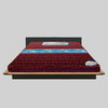 Red mattress on a wooden bed frame with a gray background