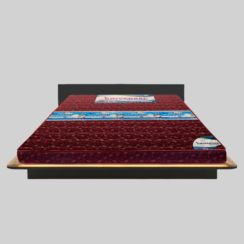 Red mattress on a wooden bed frame with a gray background