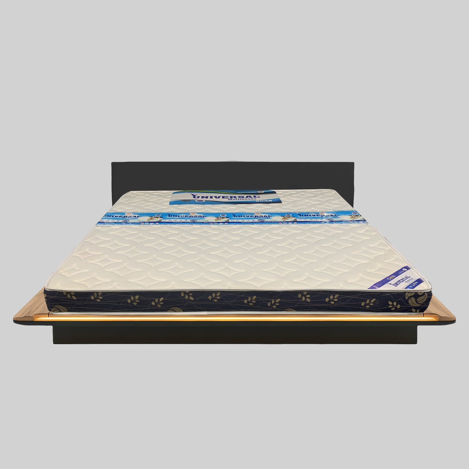 Mattress on a bed frame with 'Universal' branding on a gray background